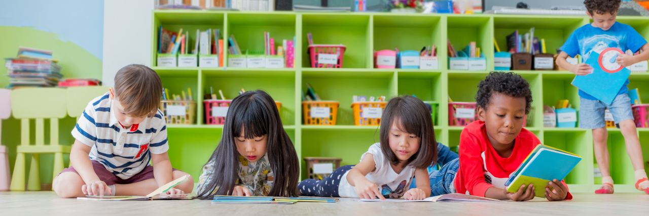 Signs of Dyslexia by Grade Level a group of diverse kids reading in a classroom