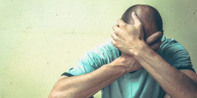 How 'the War on Drugs' Is Actually a War on Traumatized People A man sitting against a wall, his head in his hands