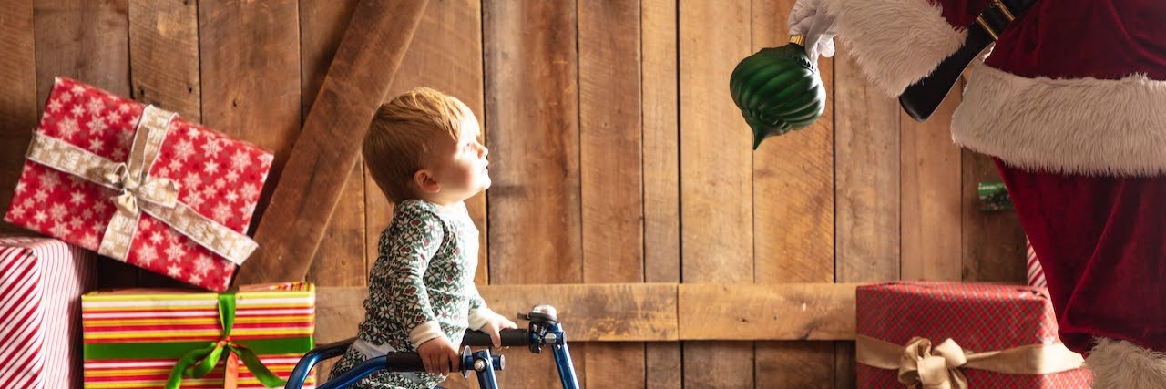 What Christmas Time Means When Your Baby Has Cancer The author's son using his walker, looking at Santa