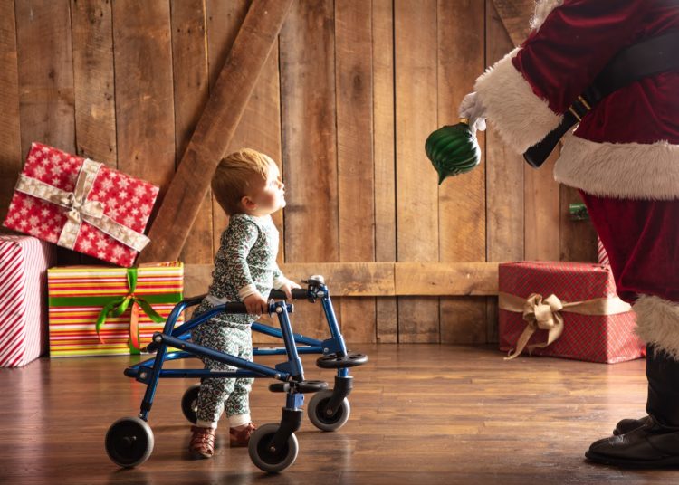The author's son using his walker, looking at Santa