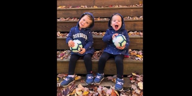 The Impact the COVID-19 Pandemic Has Had on My 2-Year-Old Twins' Cancer Diagnosis twin toddler girls sitting on steps laughing with balls