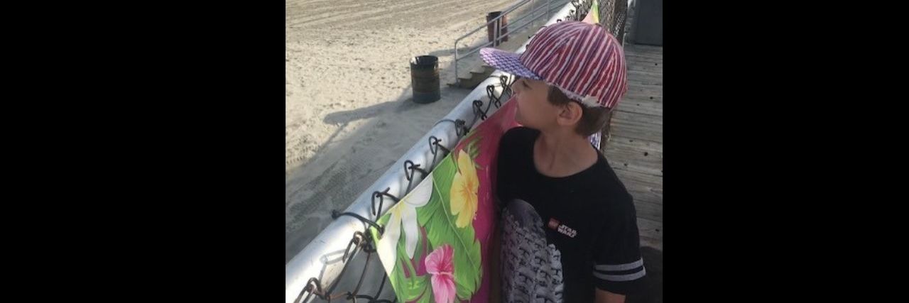 What I Learned From My Son With Autism on a Summer Day at the Pool a young boy staring in the distance