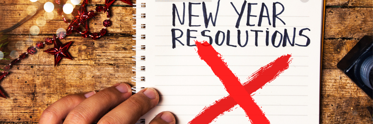 Why Depression Makes New Year’s Resolutions Impossible A hand holding a list that says "new Year Resolutions" that's been x'ed out