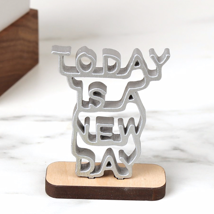 photo of a sculpture with the words Today Is a New Day