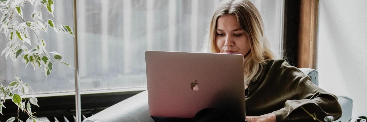 Mental Health Support Tools to Use Between Therapy Sessions photo of woman on a chair with a laptop on her knees