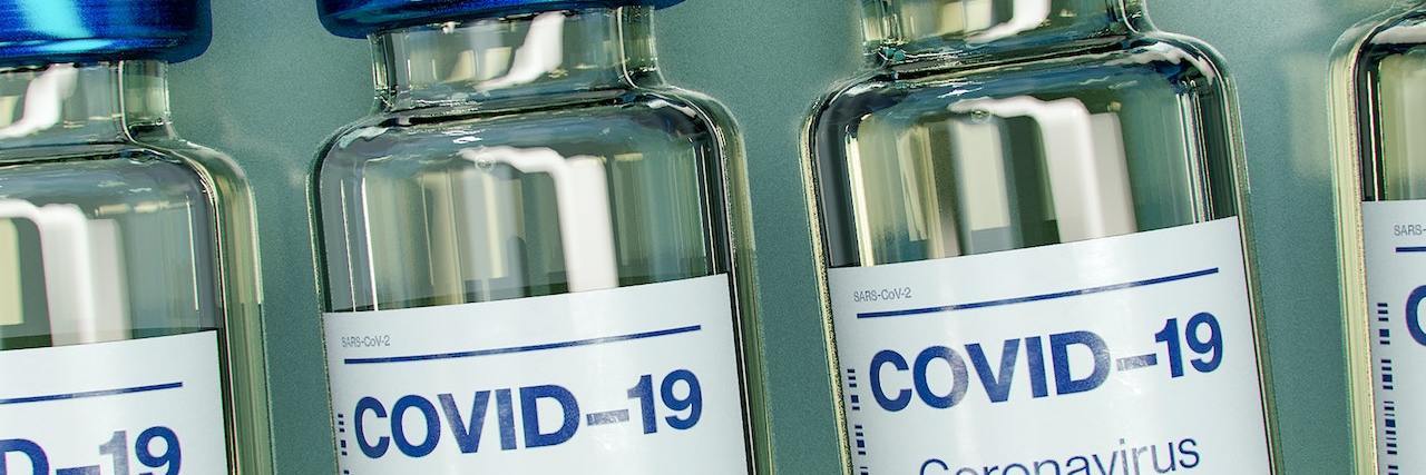 COVID-19 Vaccine Calculator: When Can I Get the COVID Vaccine? Line of COVID-19 vaccine bottles