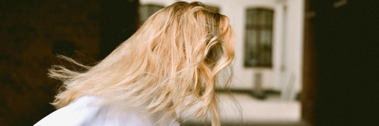 Psychotic Episode in Public? Here's What Can Happen. A woman running with her blonde hair swept behind her