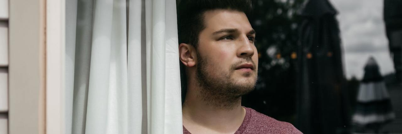 When You're Just Existing — Not Living — With Schizophrenia A man looking out a window