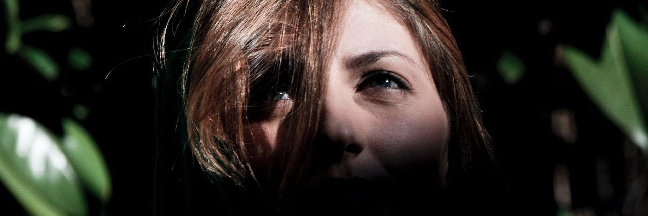 Self-Determination Theory for Hospitalized Suicide Attempt Survivors A woman in darkness, looking up at the light