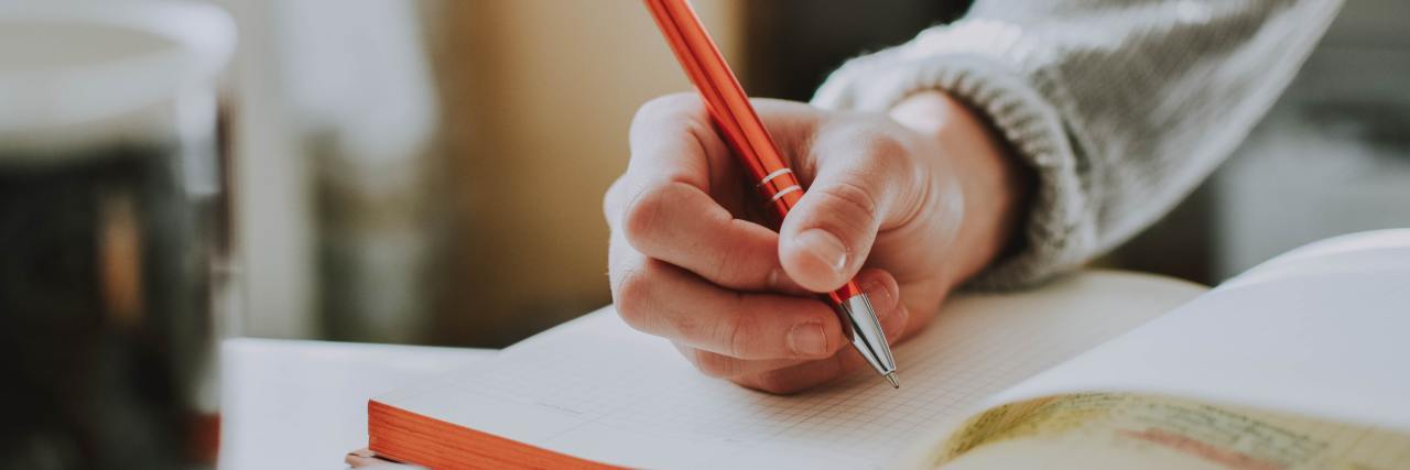 Person writing in a notebook