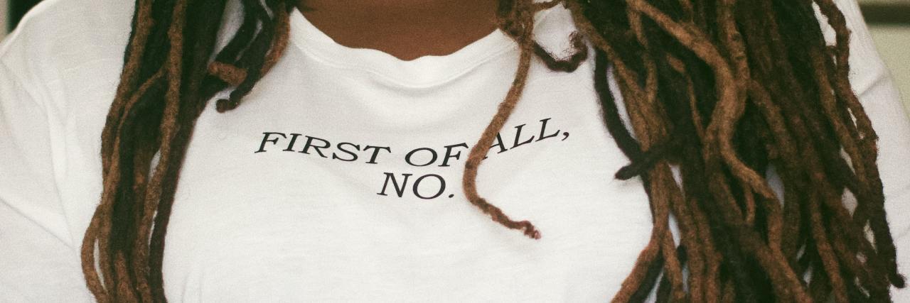 Black woman wearing a t-shirt that says "First of all, no."