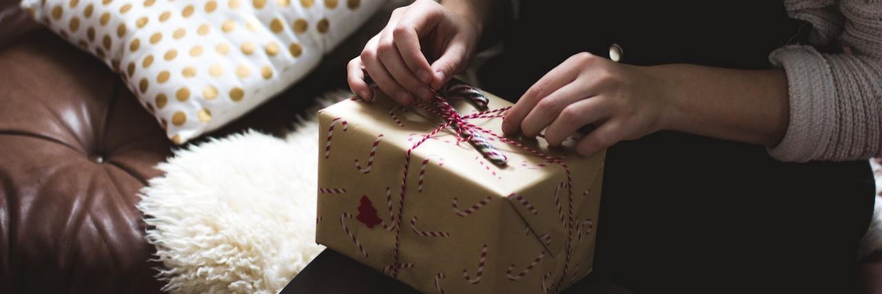 COVID-19: Tips for Handling Holiday Stress A woman opening a present