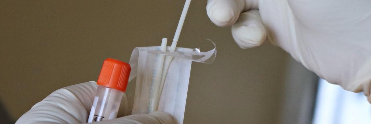 How COVID-19 Highlights the Uncertainty of Medical Testing Gloved hands put a COVID testing swab into a clear tube