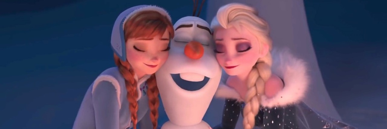 Elsa and Anna from the movie 'Frozen' hugging Olaf the snowman