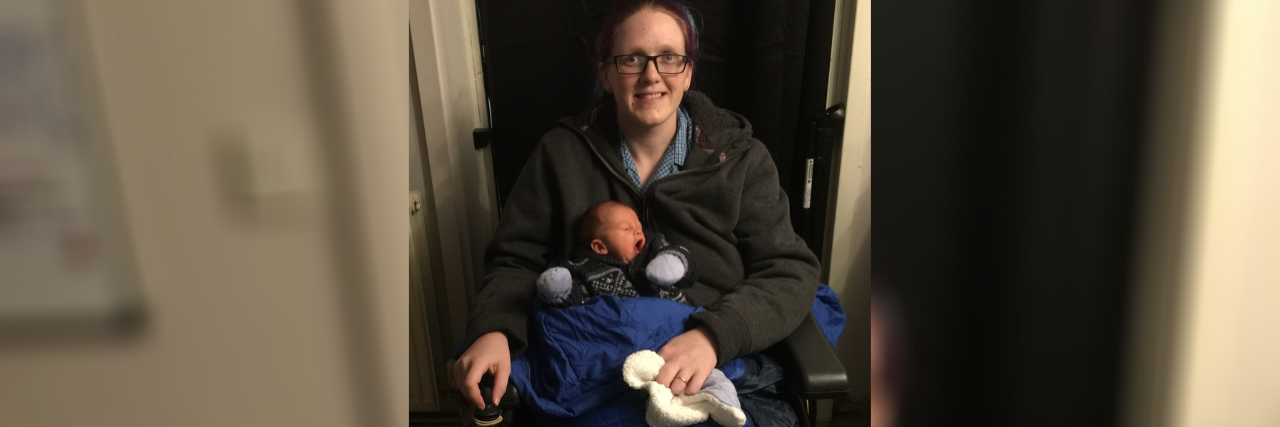 Addressing Assumptions About Parenting With a Disability Pip holding her infant son on her lap.