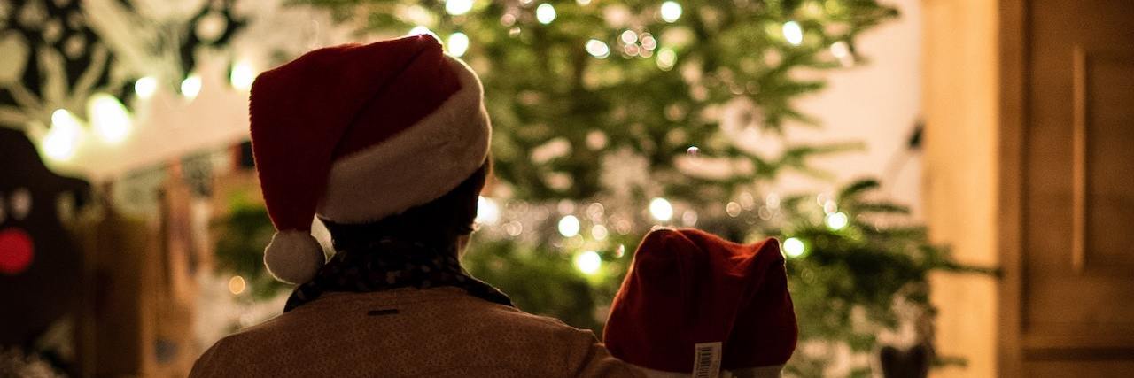 Two people looking at a Christmas tree