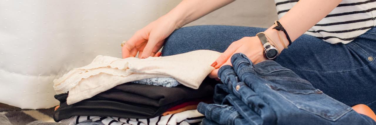 Mental Illness Makes Some 'Easy' Tasks Harder Than Others photo of folded clothes and a person's hands folding them