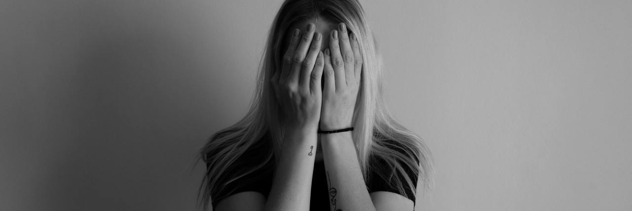 5 Things I Want You to Know About Parenting with Depression black and white photo of woman covering her face with her hands