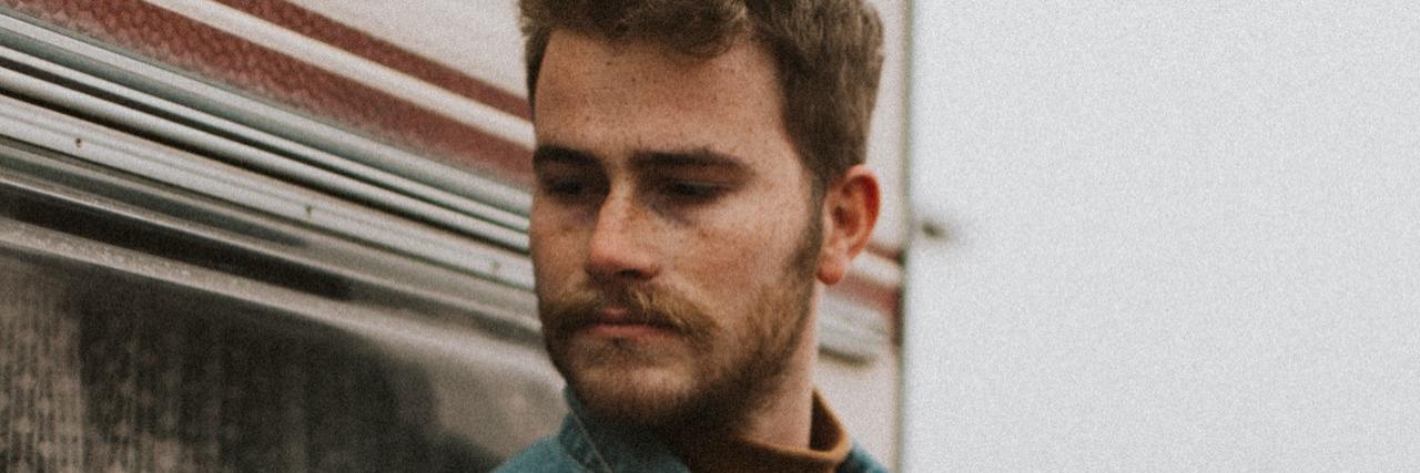 What Life in Denmark Can Teach Us About Depression Man leaning against an RV