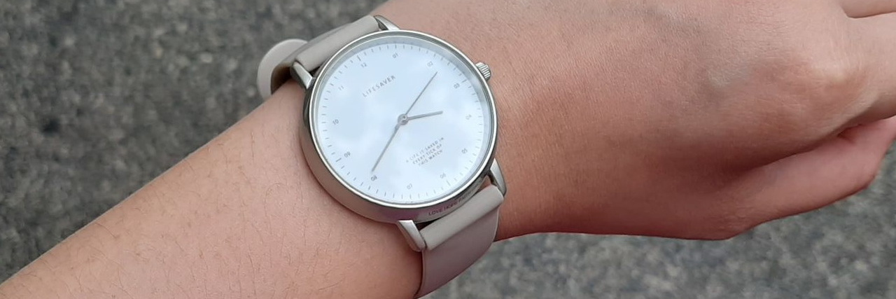 a woman's wrist with a watch