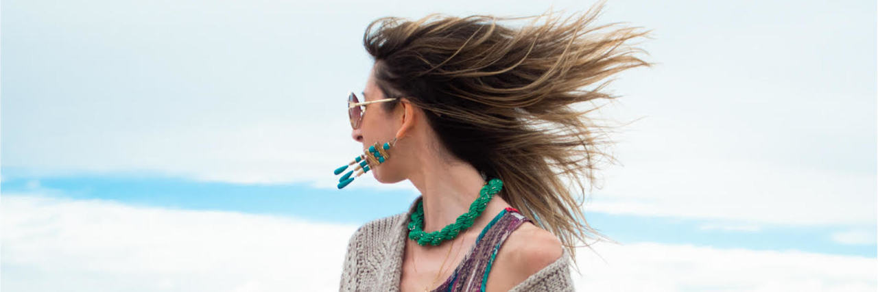 How Accepting Limits With Chronic Illness Can Make You More Creative Jenny, a white woman with long, light-brown hair blowing in the wind looking away from the camera