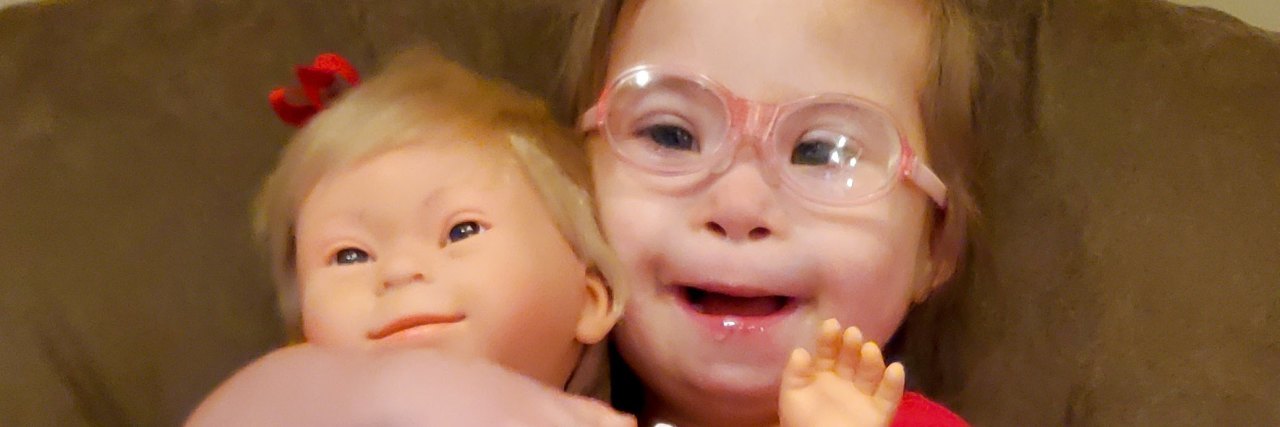 Ivy with her doll that has Down syndrome.