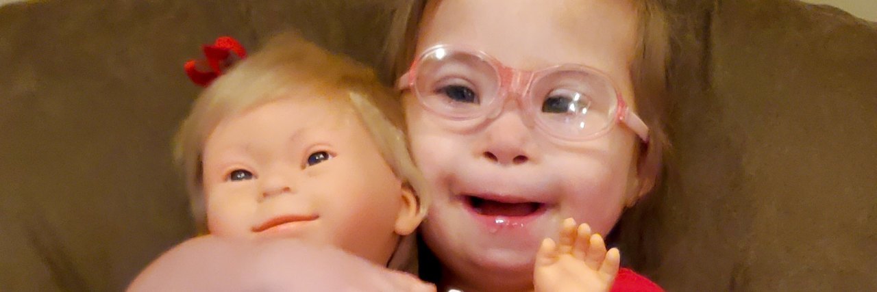 Why Disability Representation in Toys Is So Important Ivy with her doll that has Down syndrome.