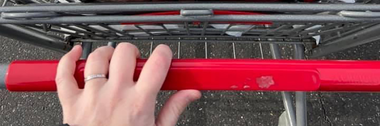 Why I Can't Unsee Signs of Alzheimer's Around Me Woman pushing shopping cart with grocery bags.