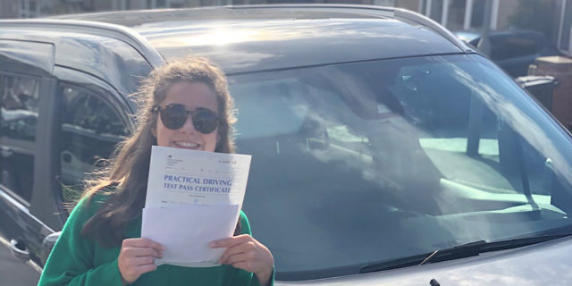 Georgia holding her driving test certificate.