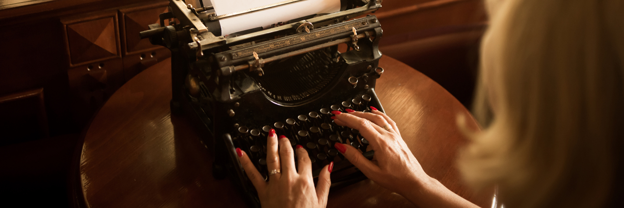 How My Gastroparesis Diagnosis Inspired Me to Write a Murder Mystery Woman using vintage typewriter.