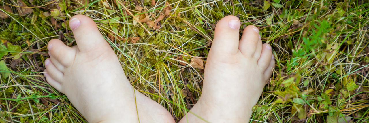 Why I Chose This Photo to Remind People to Stay Home During COVID-19 Small feet of baby with Down syndrome.