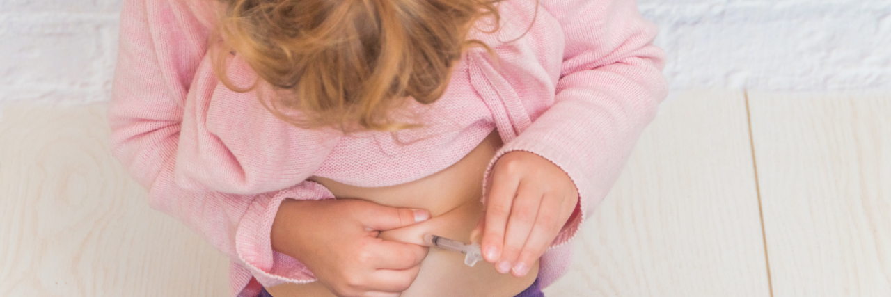 How Anxiety Prepared Us for Our Daughter's Diabetes Diagnosis Girl giving herself an insulin shot.