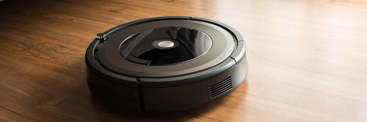 Robot vacuum cleaner on wood floor.