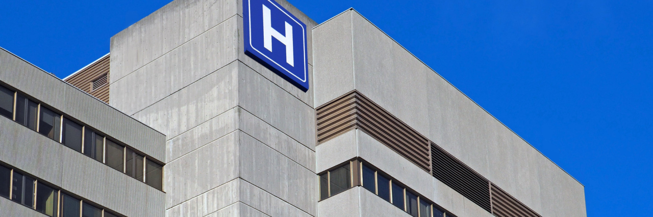 How Will Hospital Price Transparency Impact Patients? Large concrete building with H sign for hospital