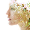 Double exposure woman's closeup portrait with flowers.