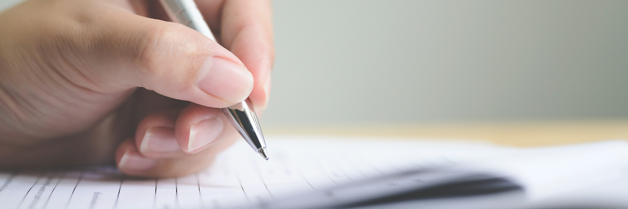 Philippa Day's Suicide Linked to Her Disability Benefits Being Cut A hand holding up a form