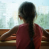 a young girl looking out a window