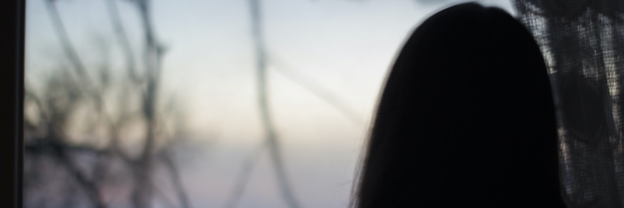 When You Didn't Realize the Extent of Your Childhood Trauma Silhouette of a woman looking out over water and sky