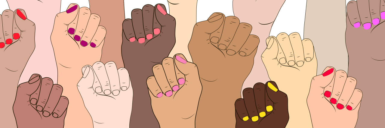 Female hands of diverse skin tones raised in fists.