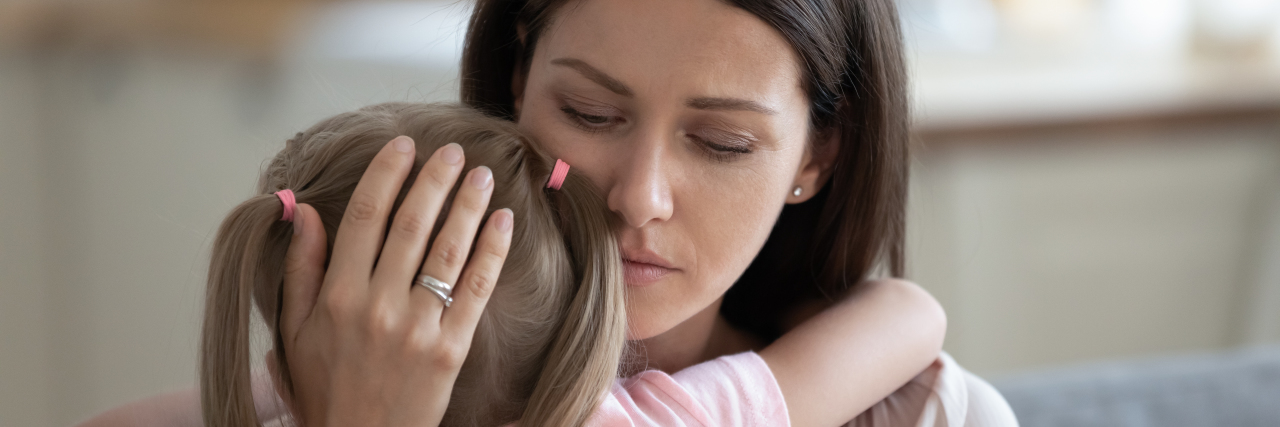 How to Help Your Child With a Disability Not Feel Like a Burden Mother hugging little girl.