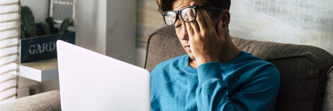 Man stares at computer frustrated