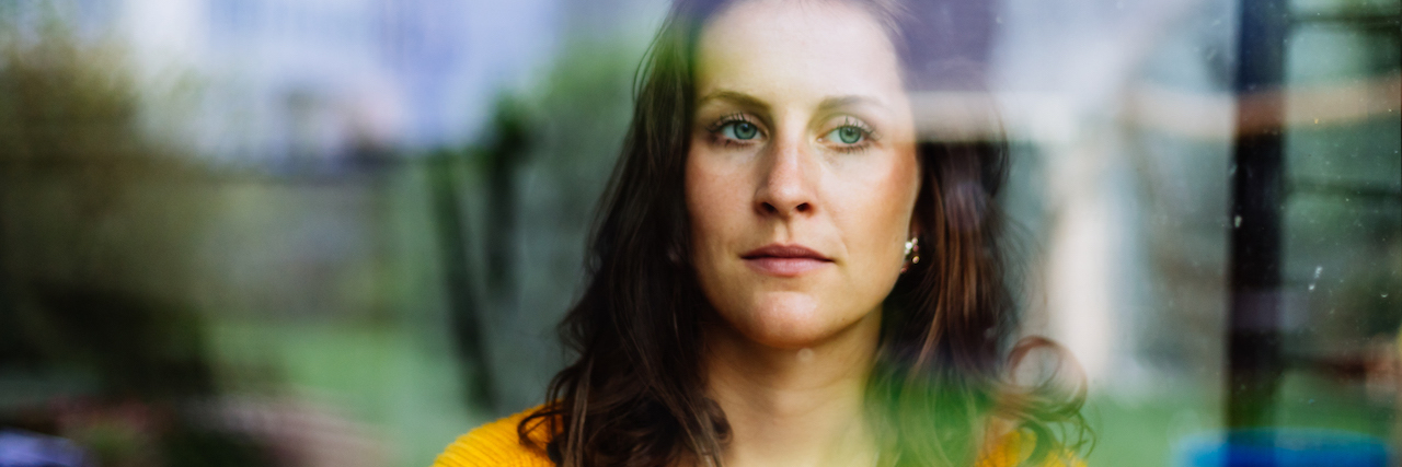 When Depression Hits: What It's Like Being a Mom With Depression A woman looking out the window