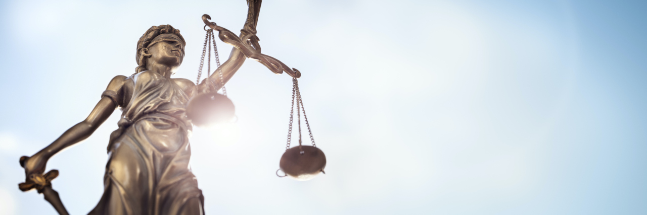 Legal and law concept statue of Lady Justice with scales of justice and sky background