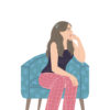 Woman sitting in armchair thinking.
