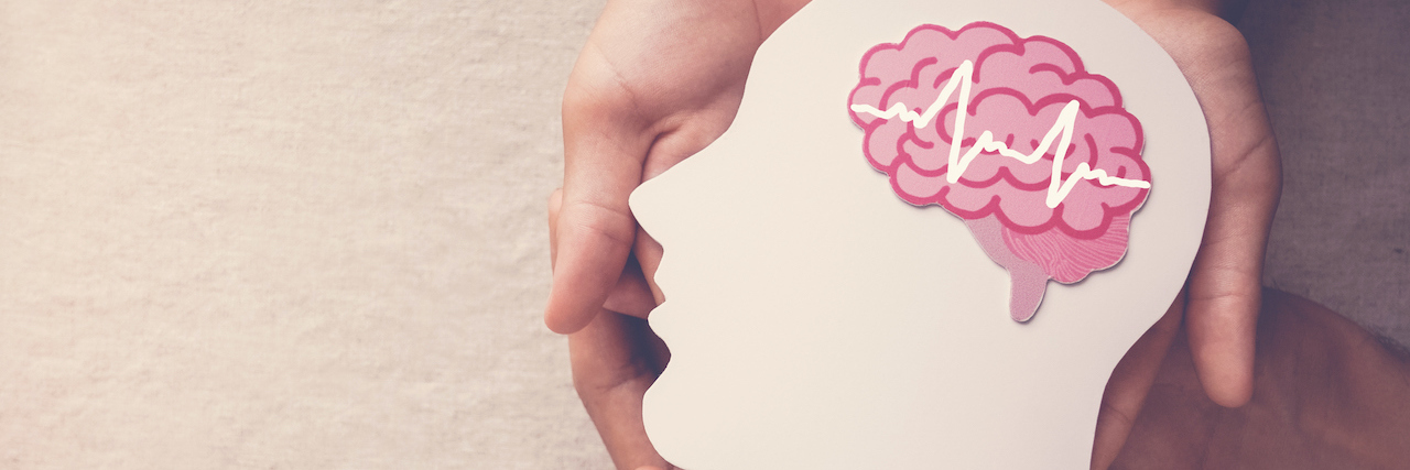 Should the Right to Die Include Mental Health? Hands holding a paper cut out of a head and a brain