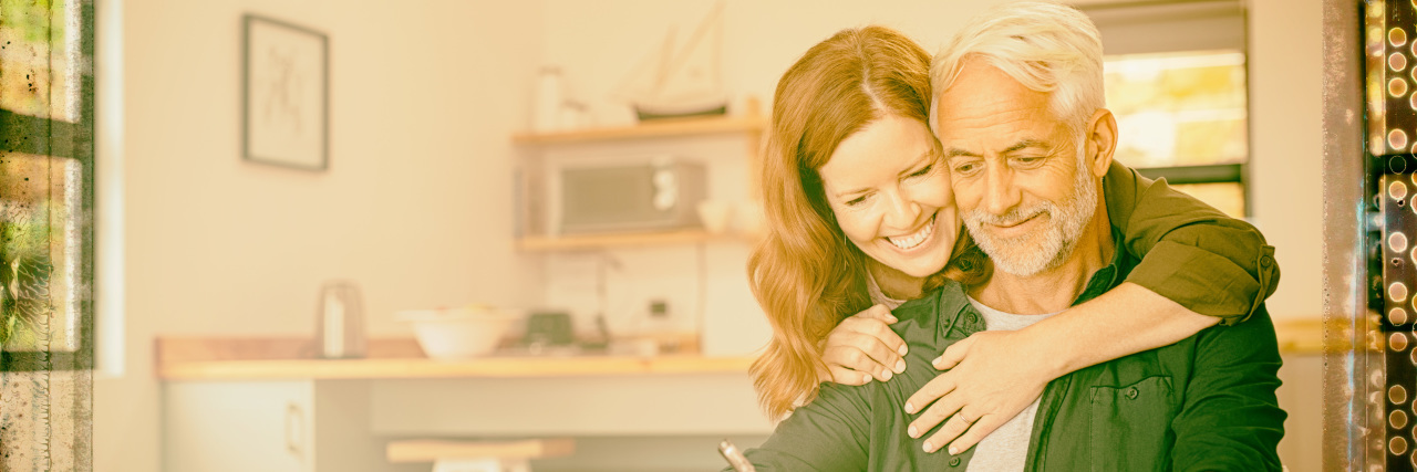 Supporting a Spouse With Aphasia After a Stroke Middle-aged couple in kitchen.