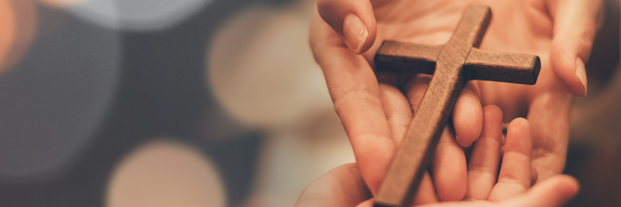 Being Christian Doesn't Mean Not Getting Help for Mental Illness Woman's hand with cross