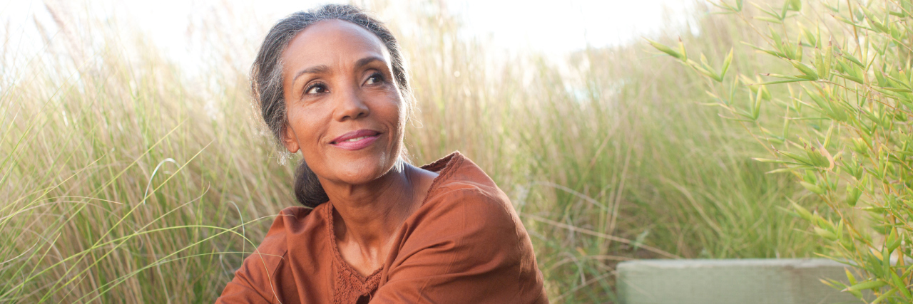 Do Antidepressants Make You 'Happy'? Serene woman sitting in sunny field