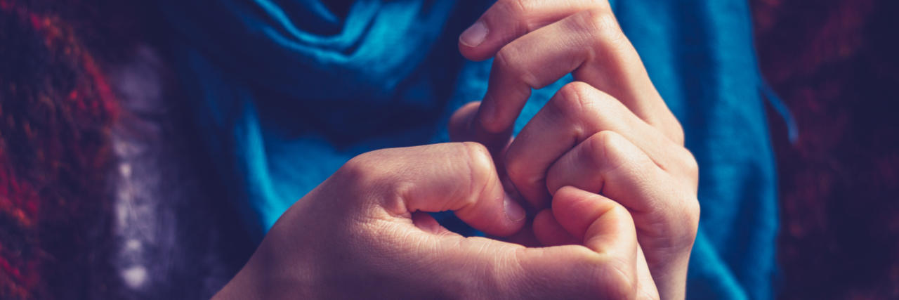 When My Dermatillomania Makes Me Feel Alone close up photo of woman picking skin on nails or hands
