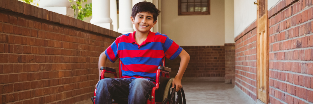 Boy sitting in wheelchair at school.